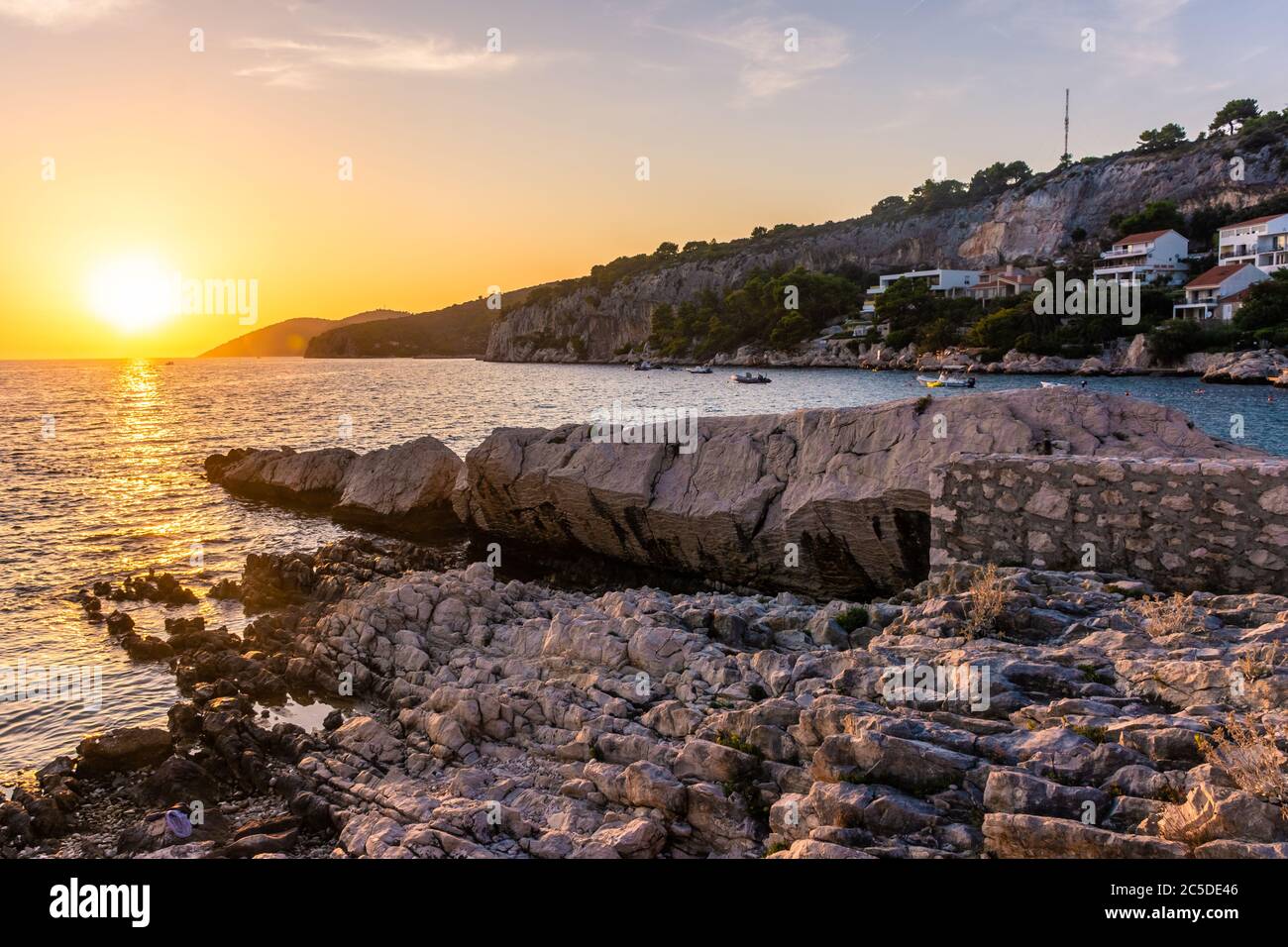 Beautiufl sunset on the rocky beach of Hvar Island, Croatia Stock Photo ...