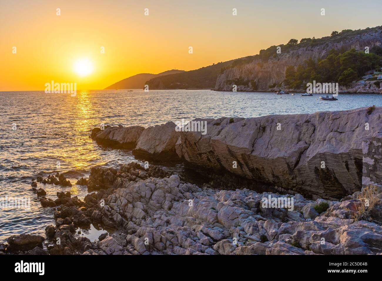 Beautiufl sunset on the rocky beach of Hvar Island, Croatia Stock Photo ...