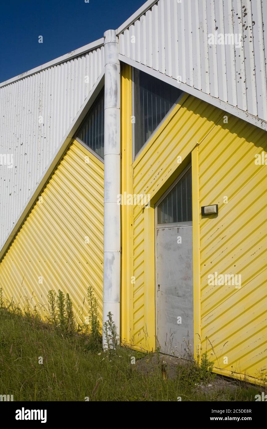 Unit with white and yellow painted sides at Kenfig industrial estate Stock Photo