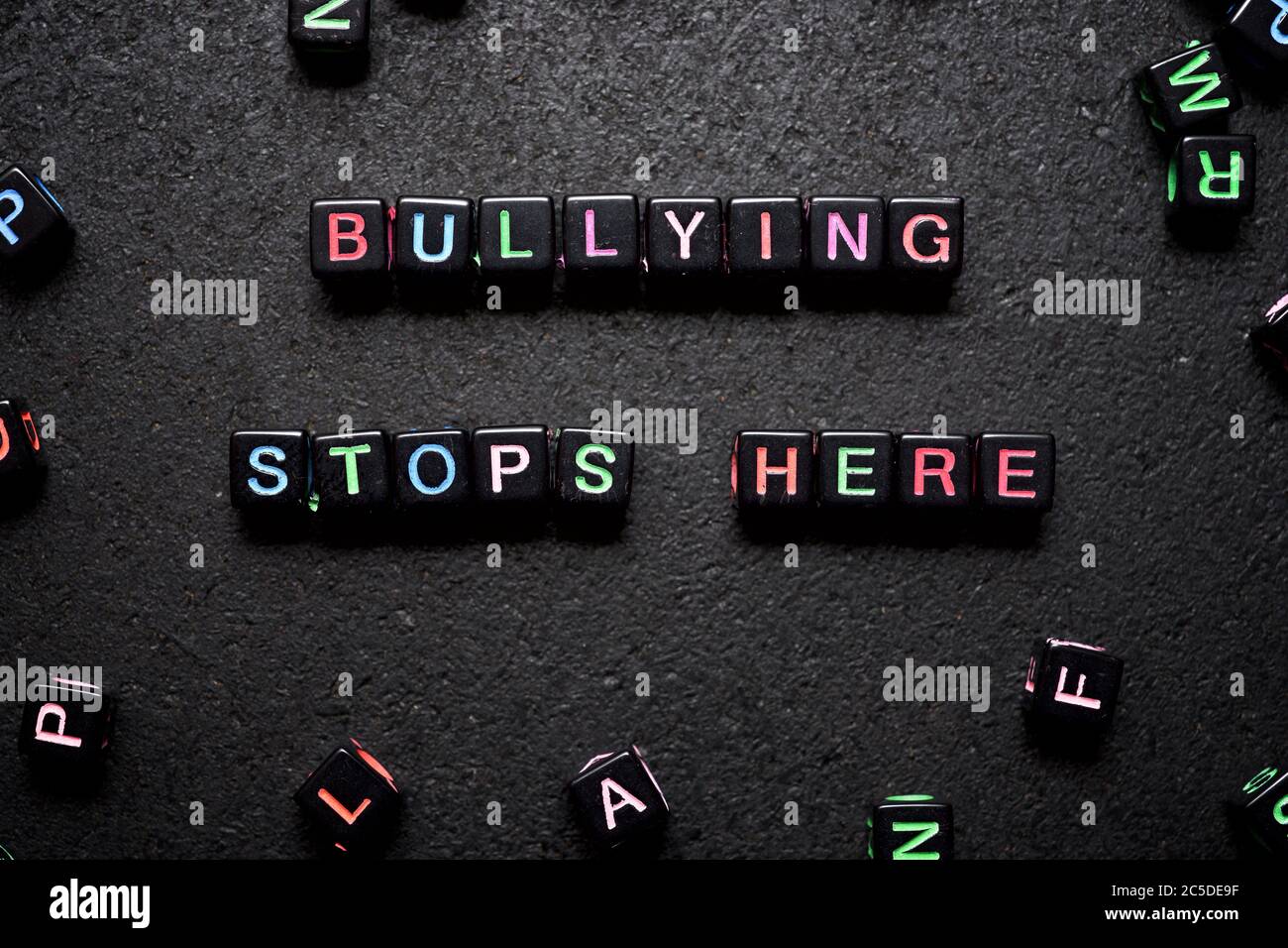 Bullying stop here sentence on a black table. Stock Photo