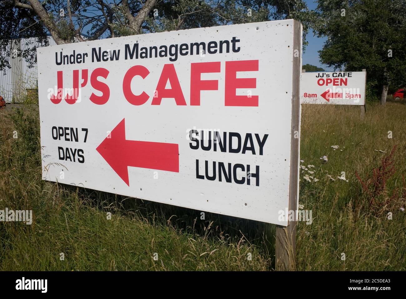 Signs to JJ's cafe, under new management, at Kenfig industrial estate with opening hours Stock Photo