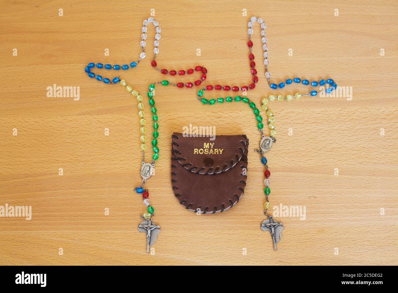 Two sets of colourful rosary beads and 'my rosary' holder Stock Photo
