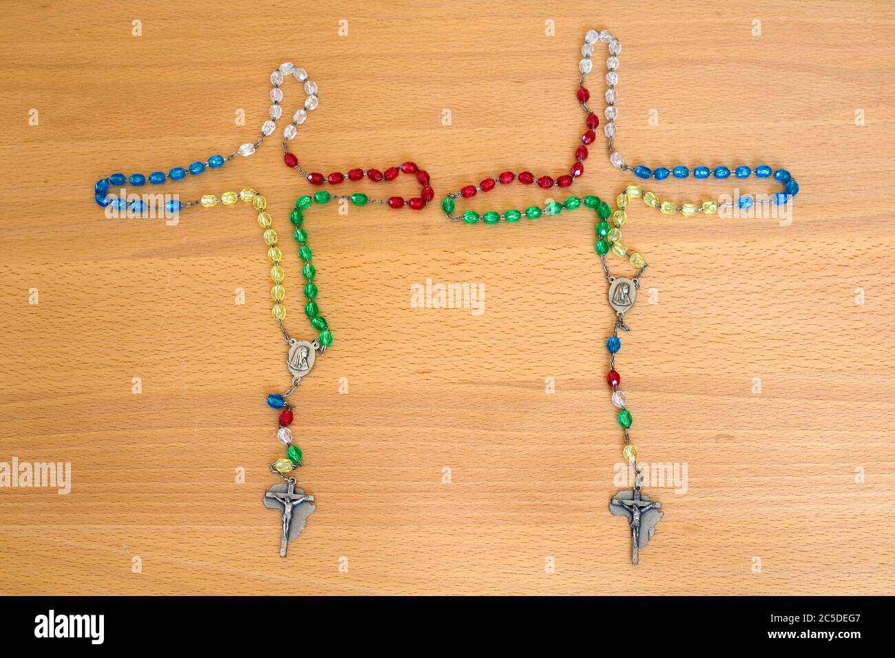 two sets of multi coloured rosary beads with Africa design crucifix Stock Photo