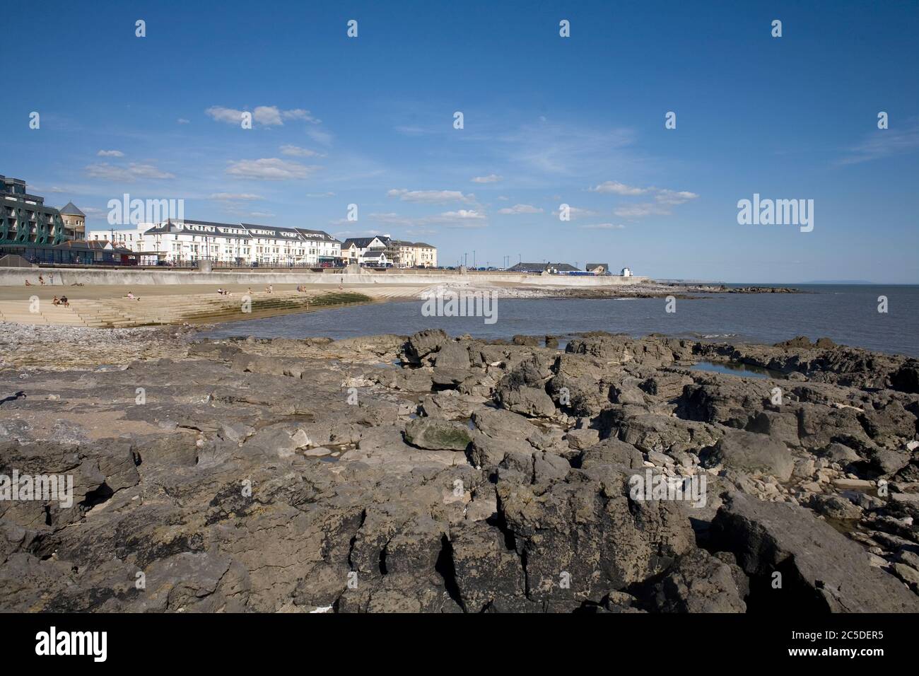 Porthcawl town centre beach with rocky foreground late in the afternoon on a warm early summer day Stock Photo