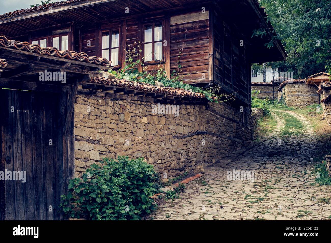 Old village cobbled lane in Bulgarian village of Zheravna Stock Photo