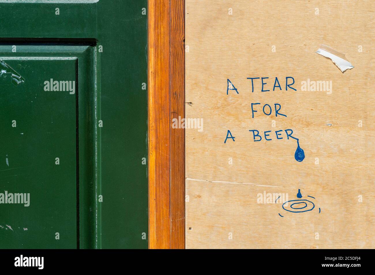 Cork, Ireland. 2nd July, 2020. Graffiti on a boarded up pub in Cork City appears to indicate the writer could do with a beer. Credit: AG News/Alamy Live News Stock Photo