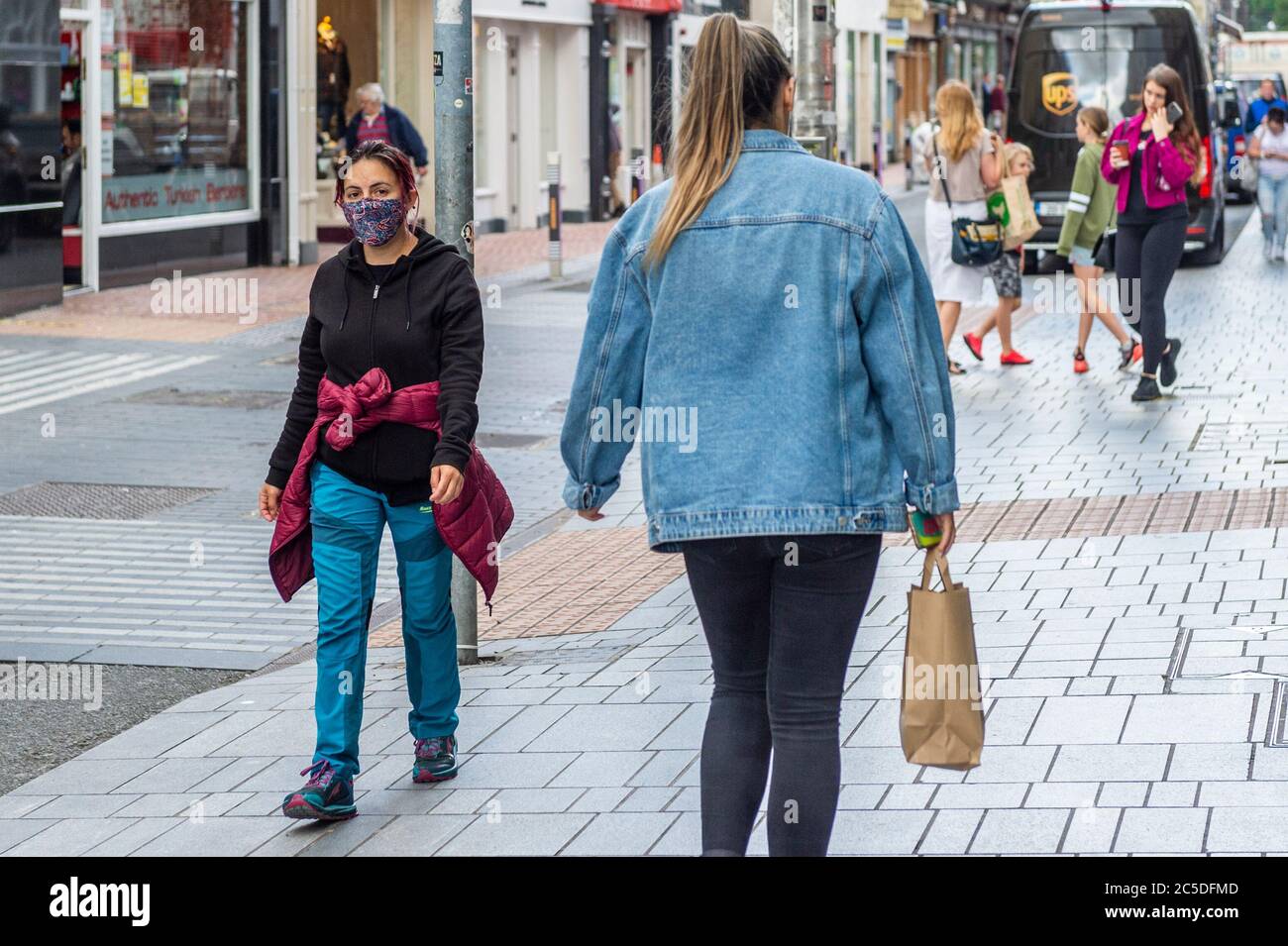 Cork, Ireland. 2nd July, 2020. A woman wears a face mask in Cork city to protect herself against Covid-19. Credit: AG News/Alamy Live News Stock Photo