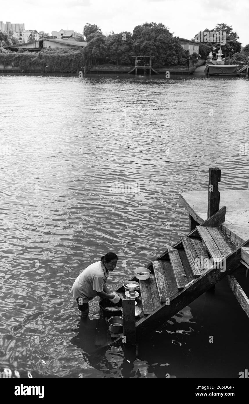 a lady was doing cleaning at pier, Ko Kret Thailand Stock Photo