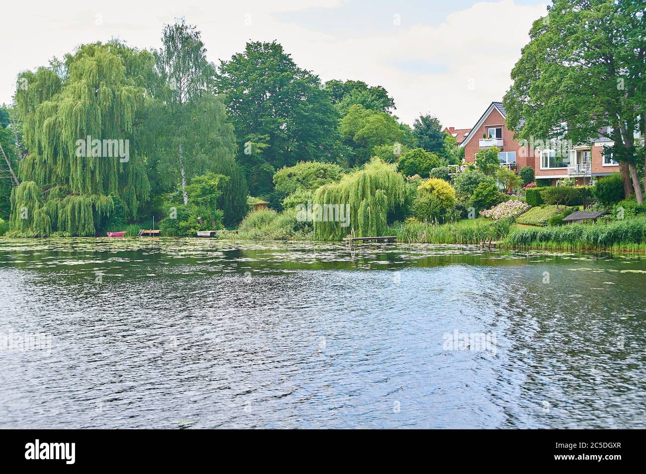 The Wakenitz river meanders through a suburb of Lübeck, passing mansions, villas and manors, Northern Germany Stock Photo