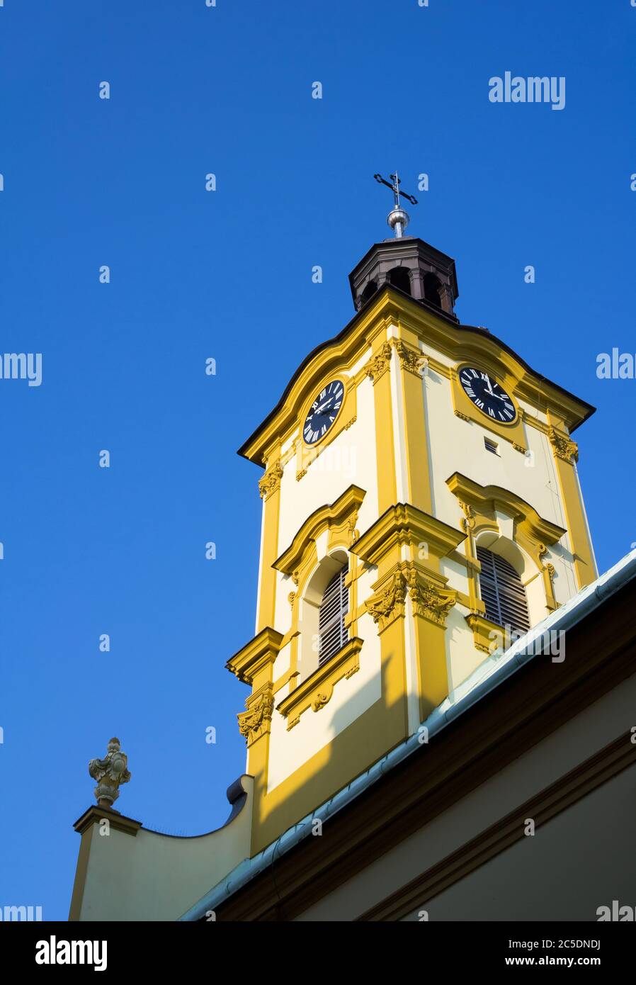 Church of Holy Cross ( Kosciol Swietego Krzyza ), Cieszyn, Silesia, Poland, Central Europe - renovated yellow bell tower of baroque church Stock Photo