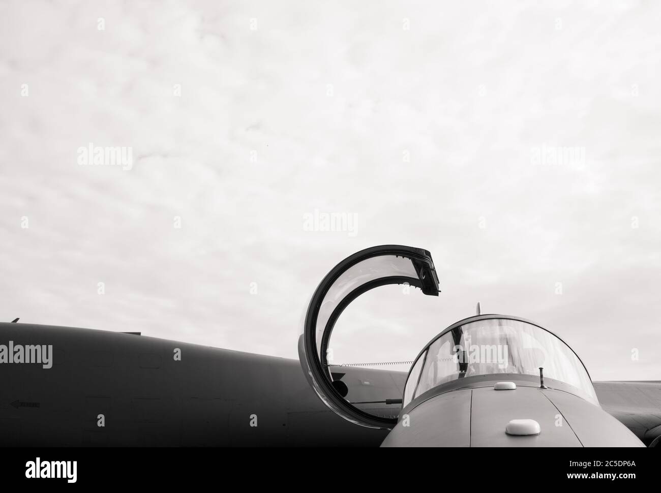 Detail of military fighter plane from the front side - cockpit of airplane is open and prepared for pilot. Black and white, copy space Stock Photo