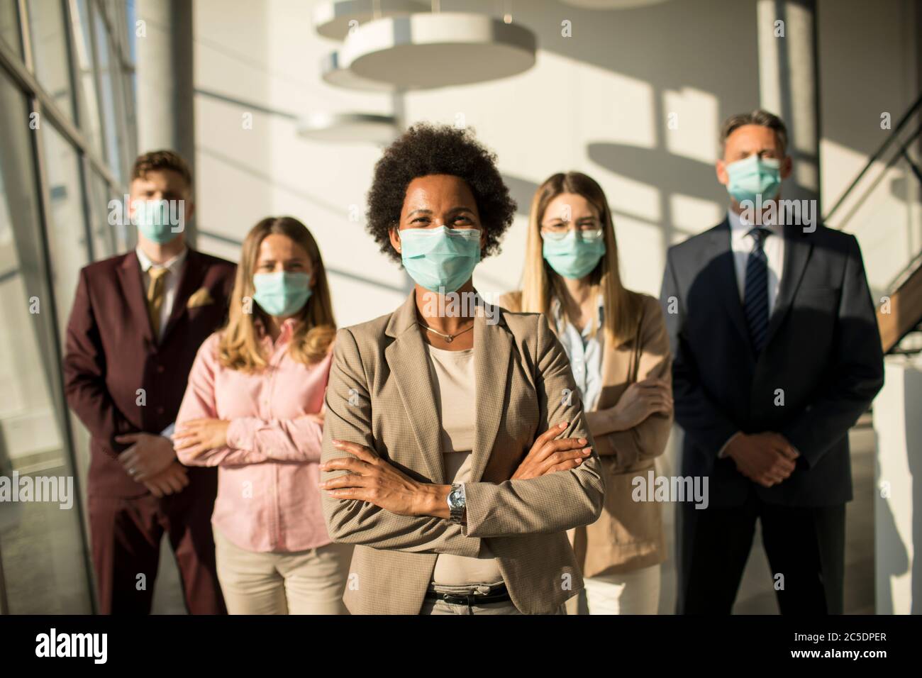 Group of asian business people standing in the office and wear mask for protect prevent infection by corona virus Stock Photo