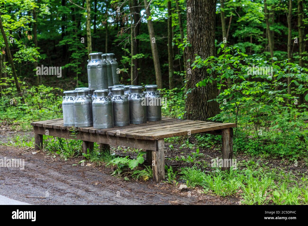 Bellville, PA, USA - May 23, 2013: Milk cans on a loading platform ready for pick up from an Amish farm in Kishacoquillas Valley in Mifflin County, PA Stock Photo