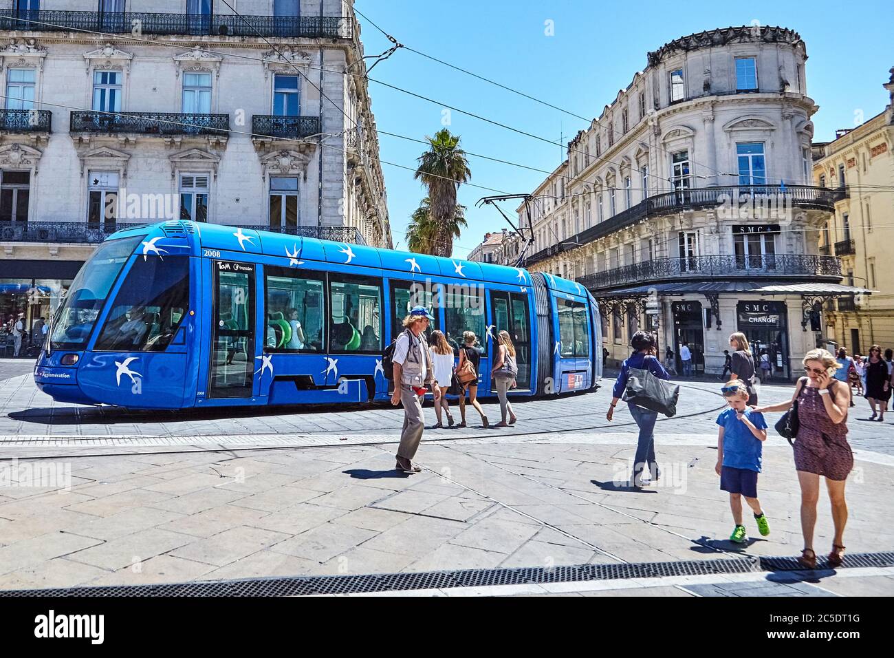 MONTPELLIER, FRANCE - June 24, 2015: Architecture of Place de la Comedie. Pedestrians and blue tram. City public transport on street Stock Photo