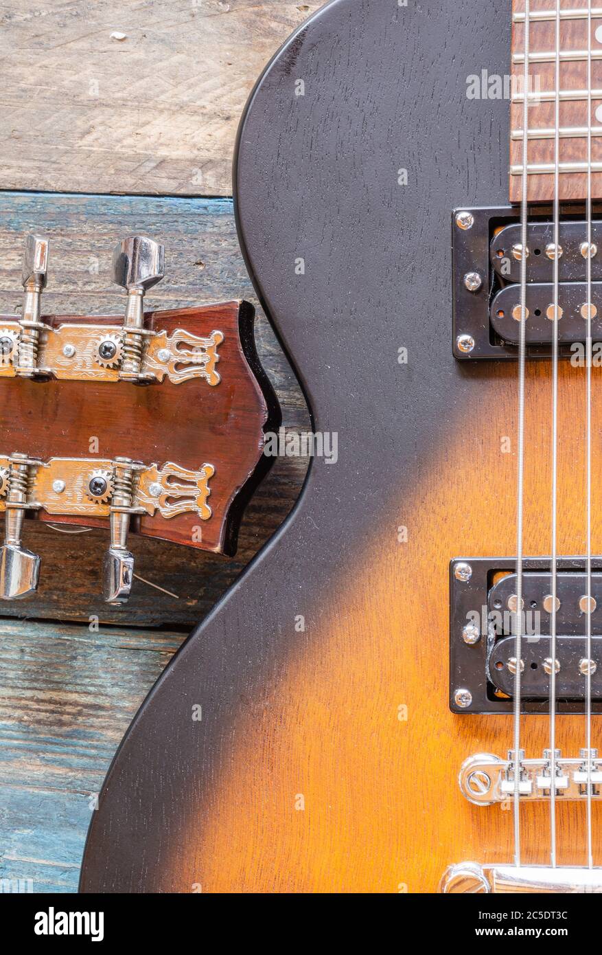 Electric guitar body. Wooden Musical Instrument. Guitar Details. Guitar bridge with strings. Stock Photo