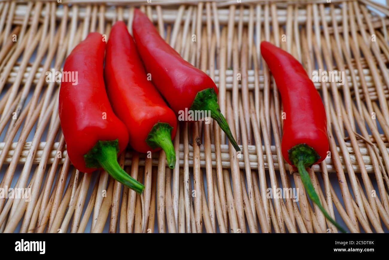 Four red chillies in a basket Stock Photo