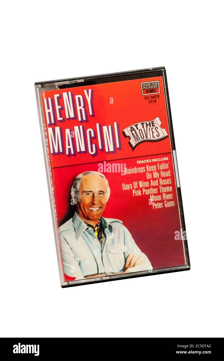 A pre recorded music cassette compilation of film themes by Henry Mancini titled Henry Mancini At The Movies , released in 1986. Stock Photo