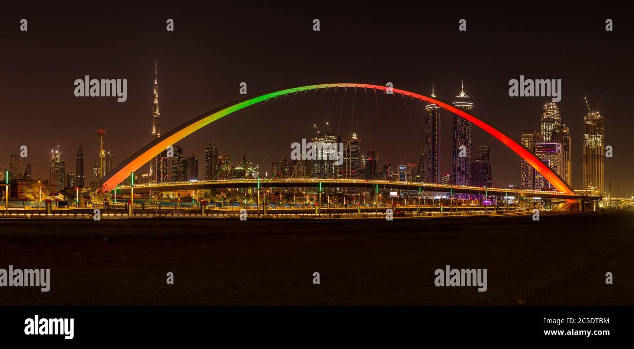 Tolerance Bridge in Dubai at night with impressive Dubai skyline in the background Stock Photo