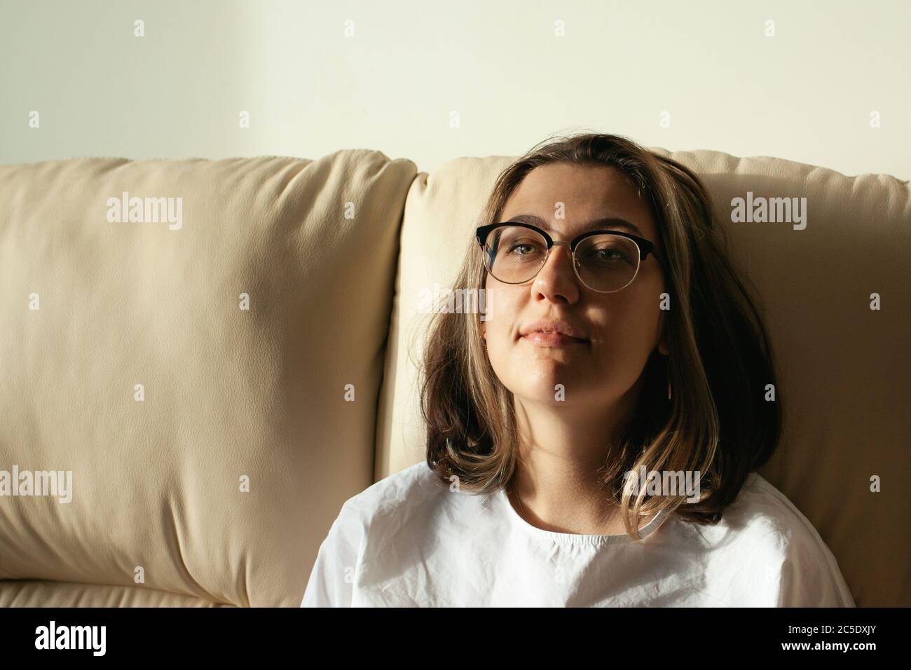 Portrait of young woman at home. The concept of natural beauty, femininity, feminism, body positive. Stock Photo