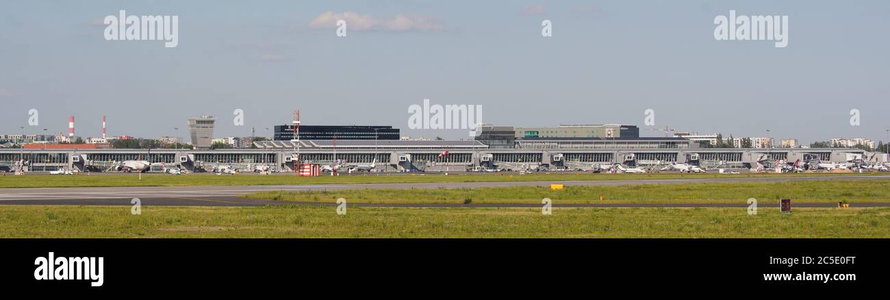 Terminals and a runway are seen at Chopin International Airport on July 1, 2020 in Warsaw, Poland. Poland has extended the list of flights to 8 non-EU Stock Photo