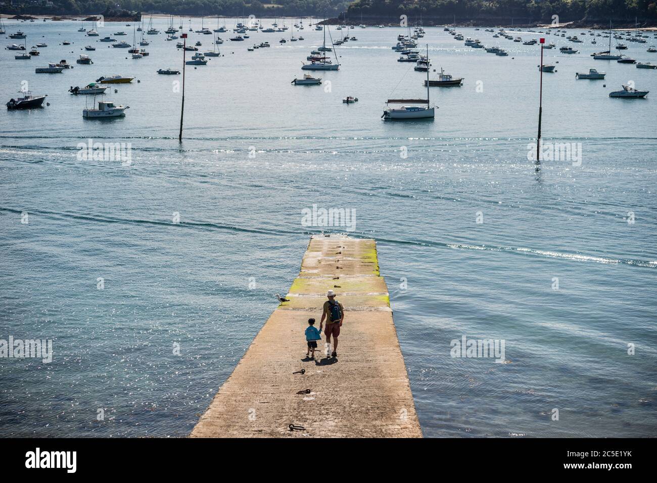 Father and child walking on jetty, Dinard, Brittany, France Stock Photo