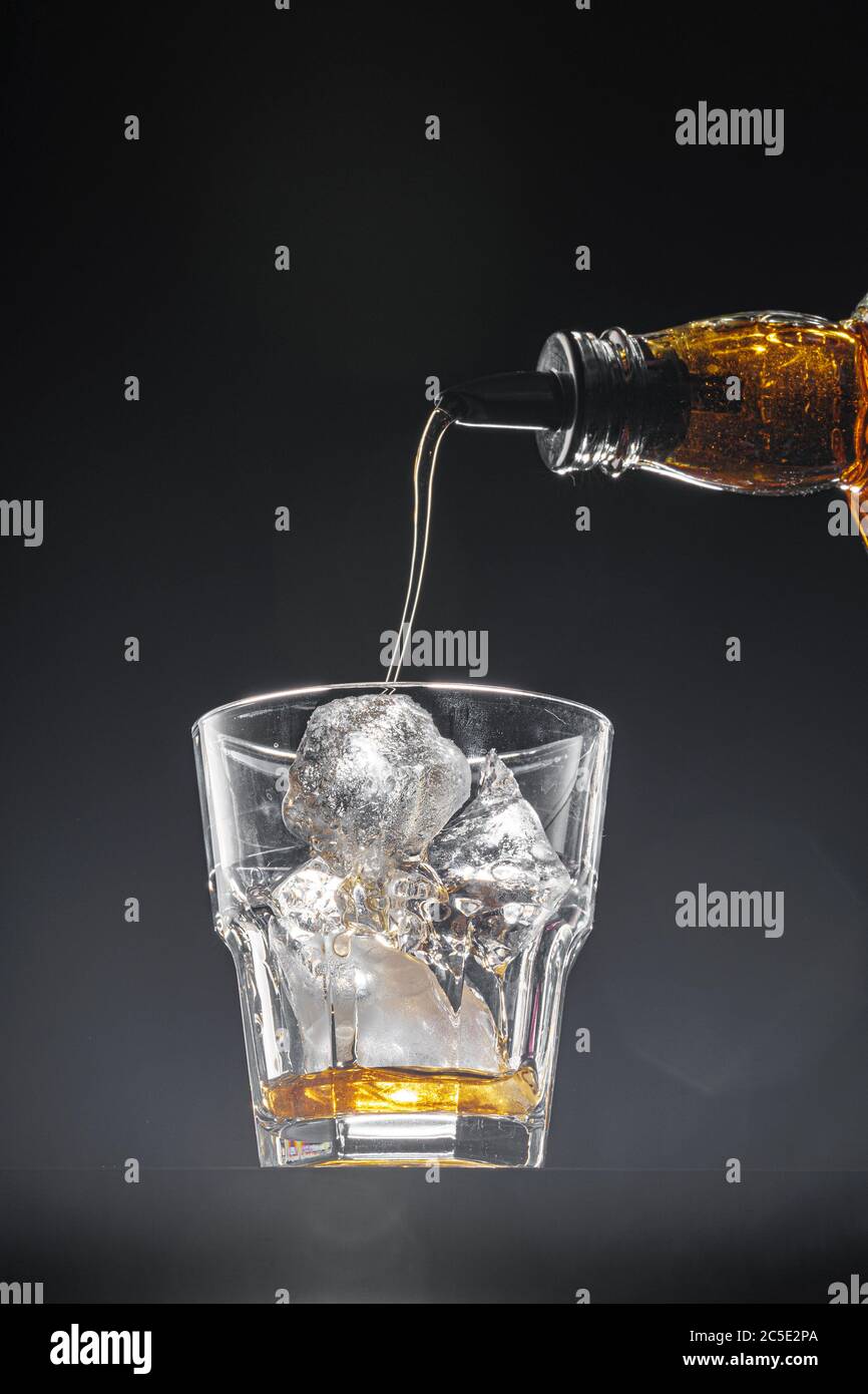 Glass of Whiskey, Bourbon or Brandy with Ice Cube on White Isolated  Background. Glass for Alcohol Drink Stock Photo - Image of macro, plastic:  215386878