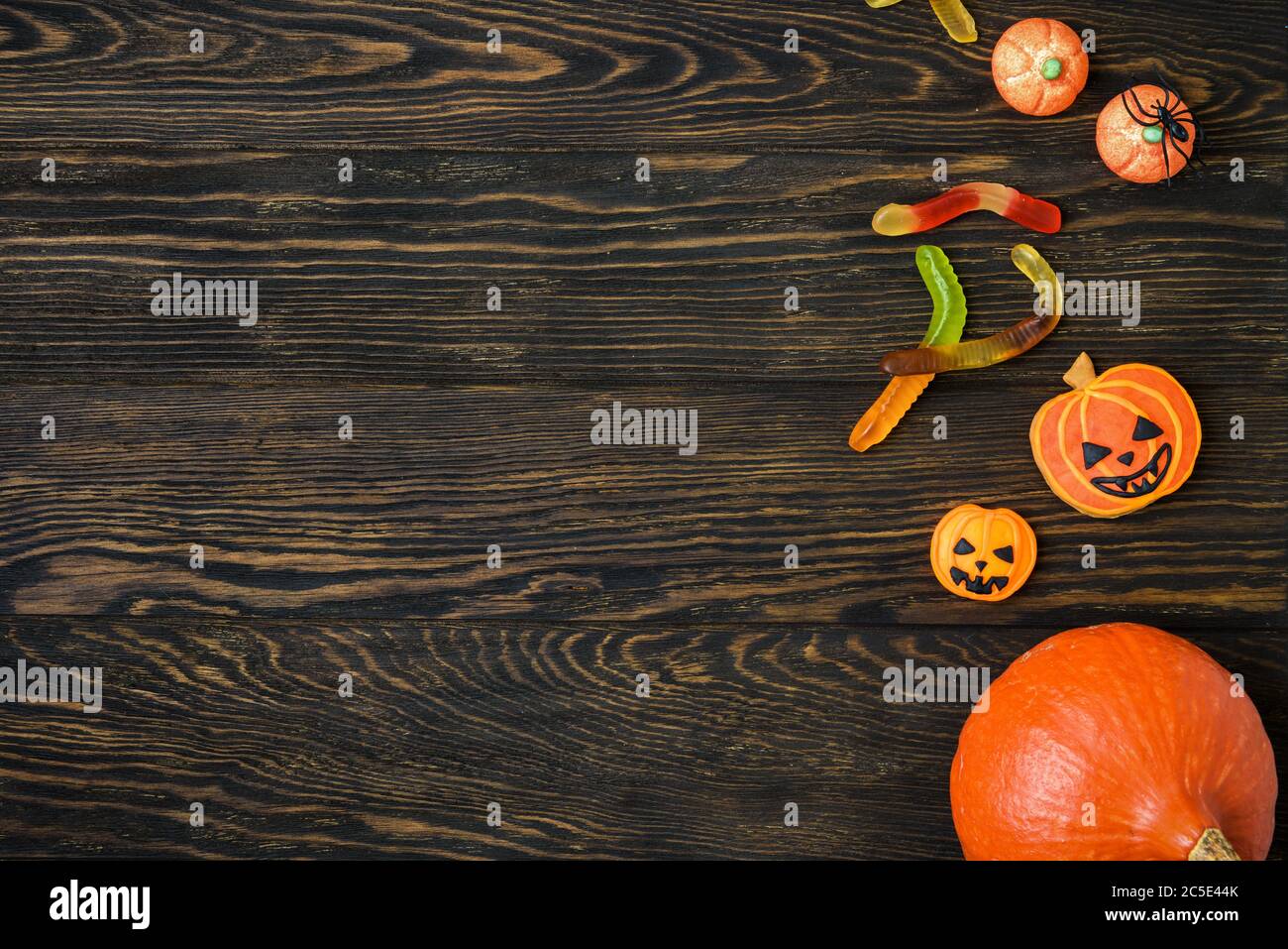 Halloween holiday background with pumpkins, candy and spider. View from above. Stock Photo