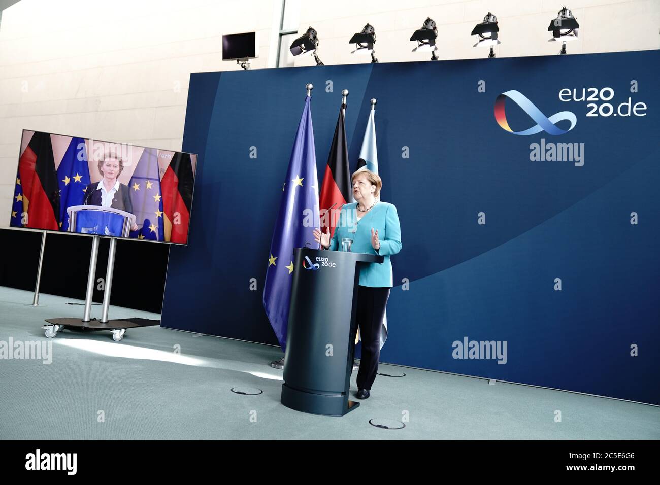 Berlin, Germany. 02nd July, 2020. Chancellor Angela Merkel (CDU) makes a statement to the press in the foyer of the Federal Chancellery. Ursula von der Leyen (CDU), President of the EU Commission, has joined in by video. One day after taking over the Presidency of the Council, Merkel is joined by the President of the EU Commission, the three executive Vice-Presidents, the Commissioner for External Relations and the Commissioner for Internal Affairs. They have coordinated the work programme for the beginning of the Federal Republic's EU Presidency. Credit: Kay Nietfeld/dpa/Alamy Live News Stock Photo
