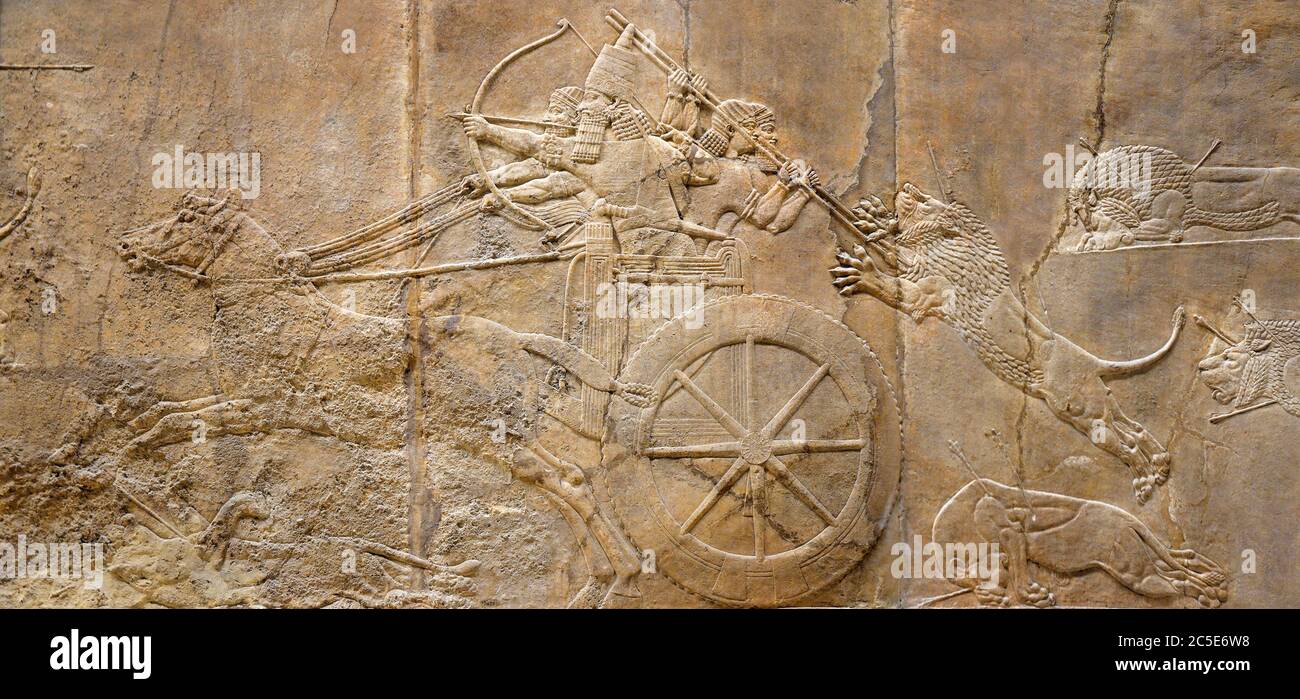 Assyrian wall relief of the royal lion hunt. Ancient carving panoramic panel from Middle East history. Remains of the culture of ancient civilization. Stock Photo