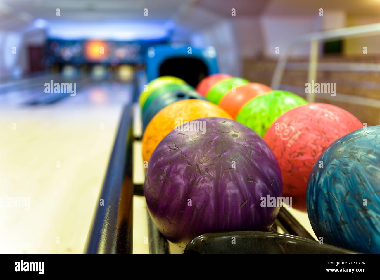 Bowling with colorful bowling balls in return machine Stock Photo Alamy