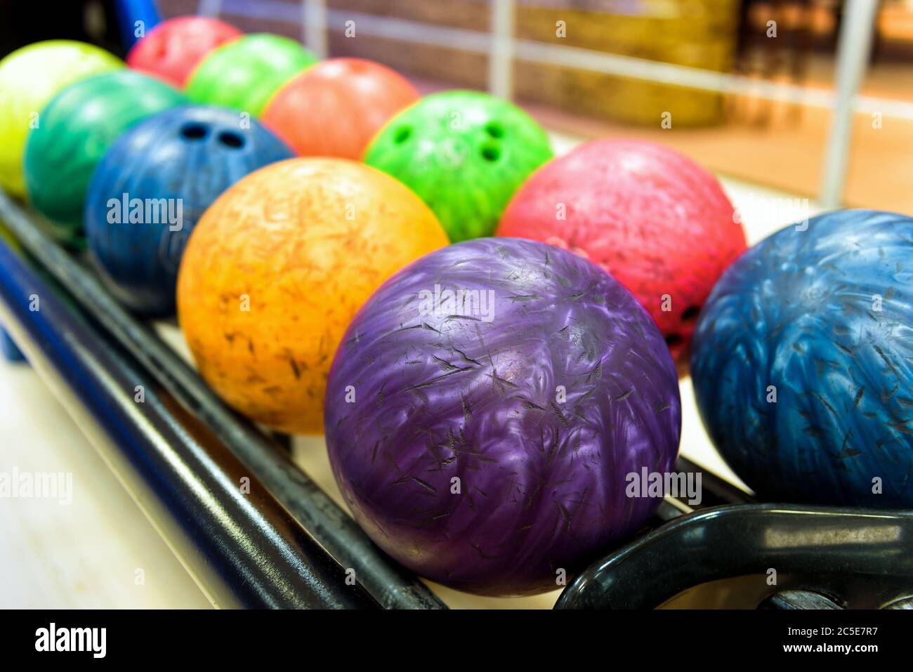 Colorful bowling balls in return machine Stock Photo Alamy