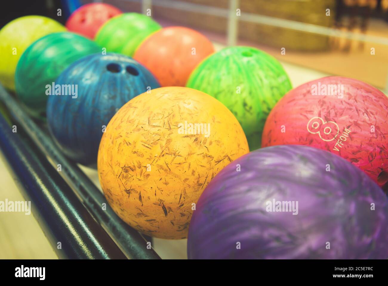 Colorful bowling balls in return machine Stock Photo Alamy