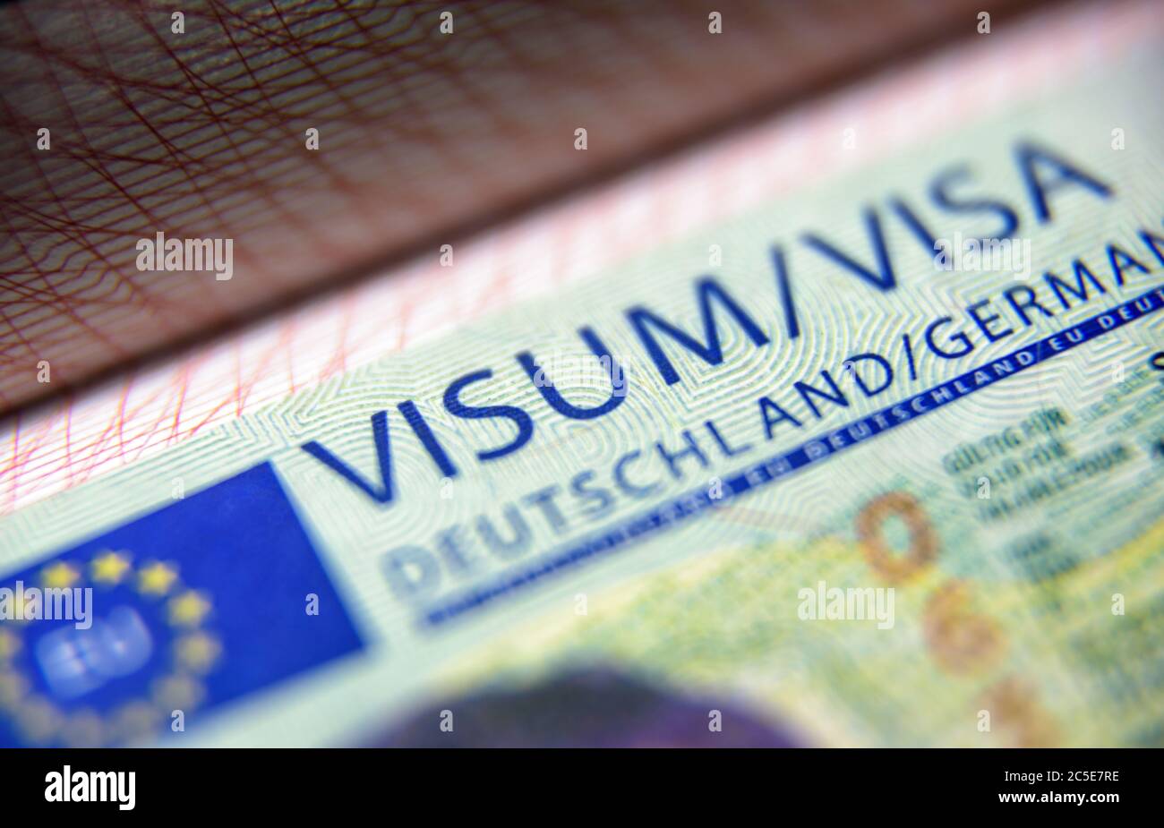 Visa stamp in passport closeup. German visitor visa at border control. Macro view of Schengen