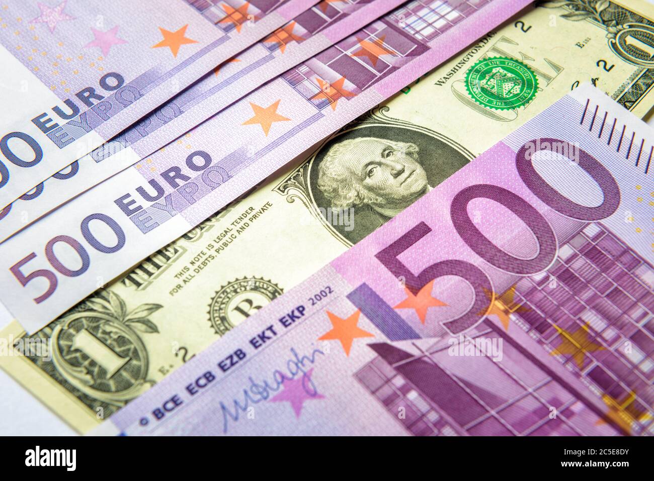 1 dollar bill versus a lot of 500 euro money banknotes. Top view of money cash. European Union currency contra one American dollar note. Concept of st Stock Photo