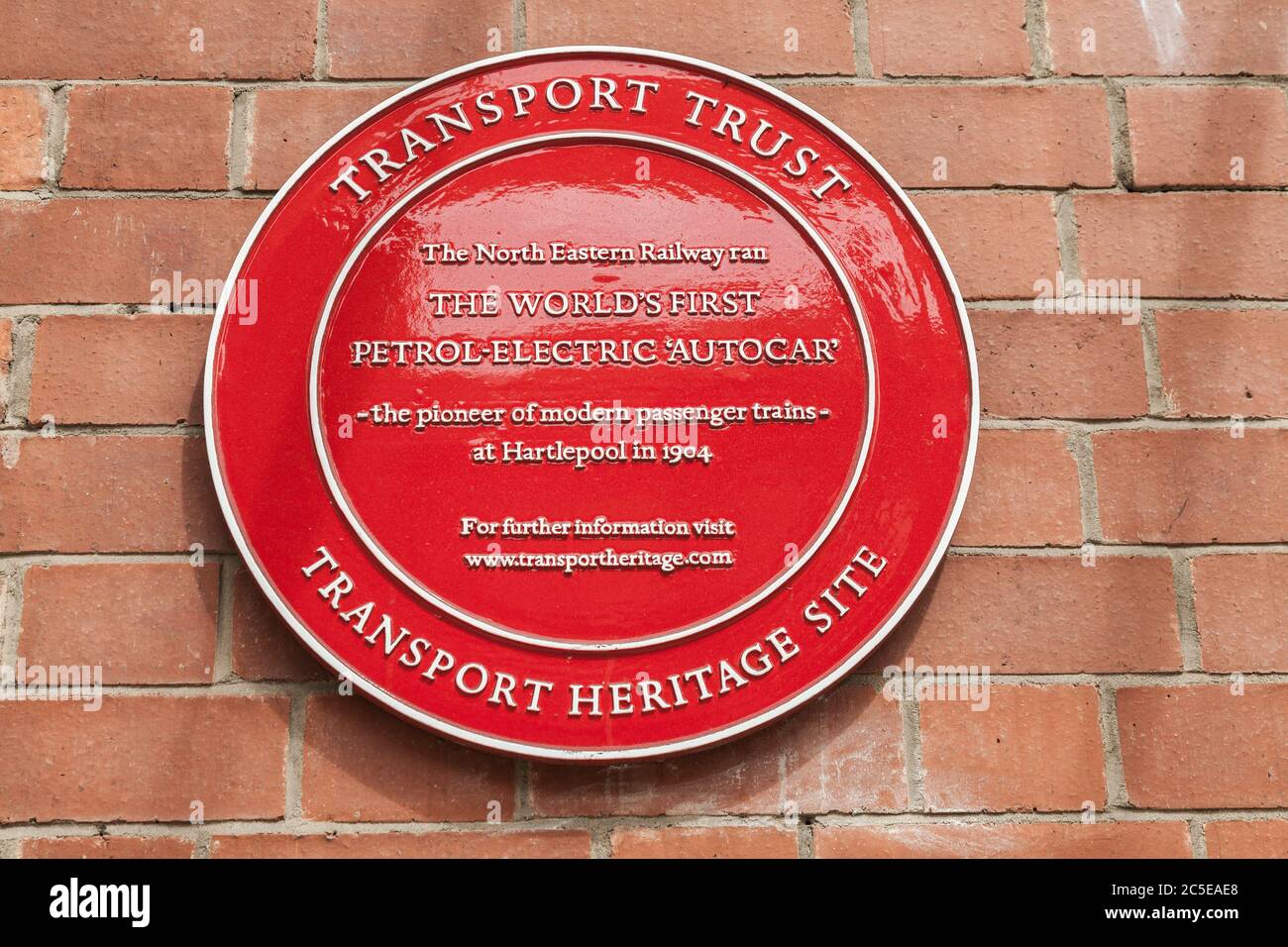 A red plaque to celebrate the introduction of the world’s first petrol-electric railway vehicle known as the Autocar which first ran in Hartlepool Stock Photo