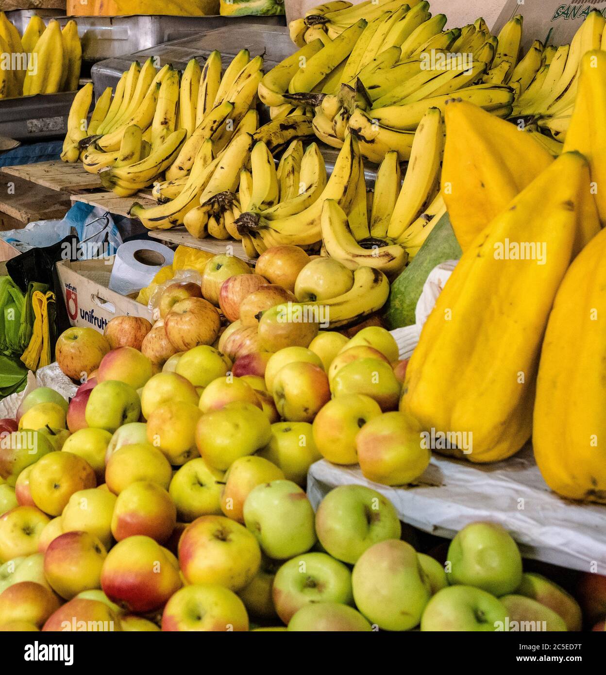 Apples, bananas and star fruit in an indoor market in Cuenca, Ecuador