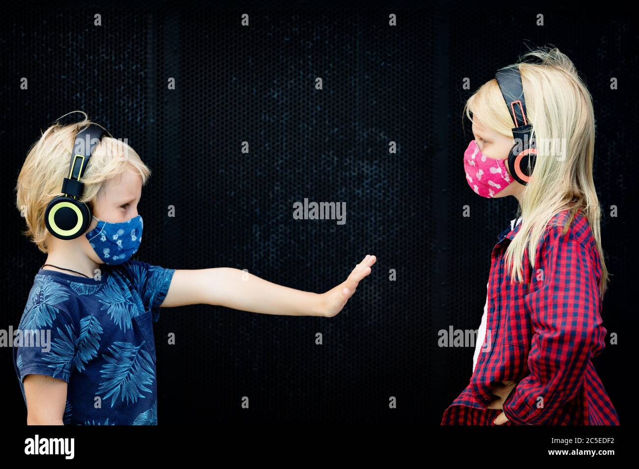 Funny children in headphones listening music keep social distance on