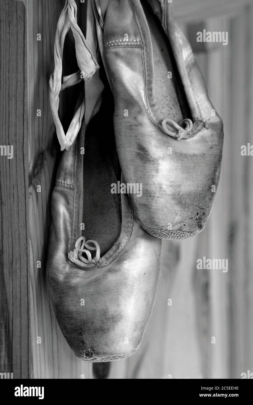 A pair of worn out ballet shoes. Stock Photo