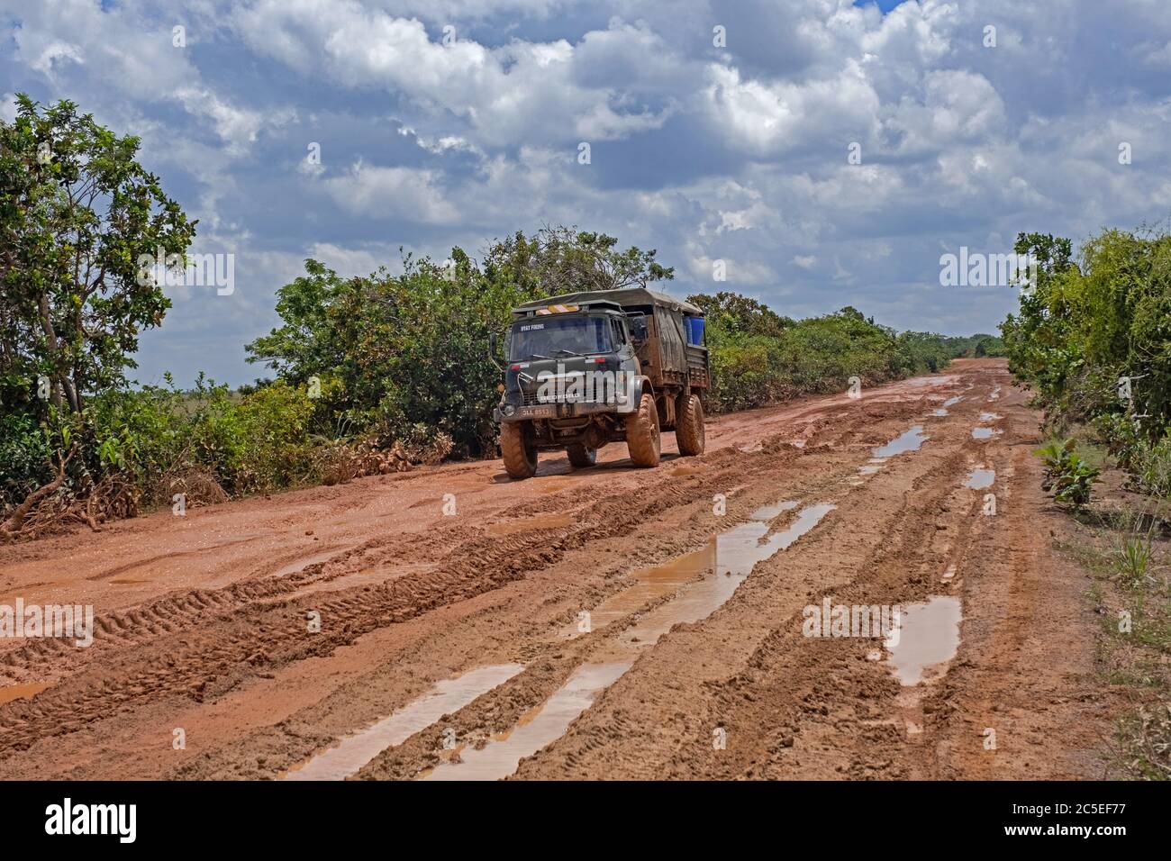 4x4 truck riding along the muddy Linden-Lethem dirt road linking Lethem and Georgetown in the rainy season, Guyana, South America Stock Photo