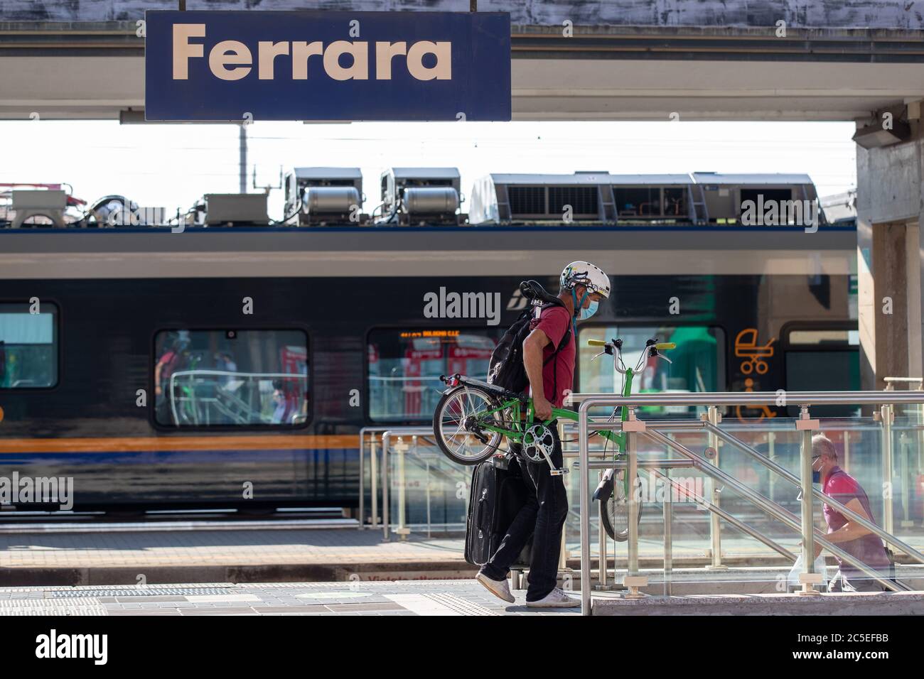 Ferrara, Italy. 2 July, 2020.  A man travels by train carrying his portable and foldable bicycle in Ferrara, Italy.   Credit: Filippo Rubin / Alamy Stock Photo