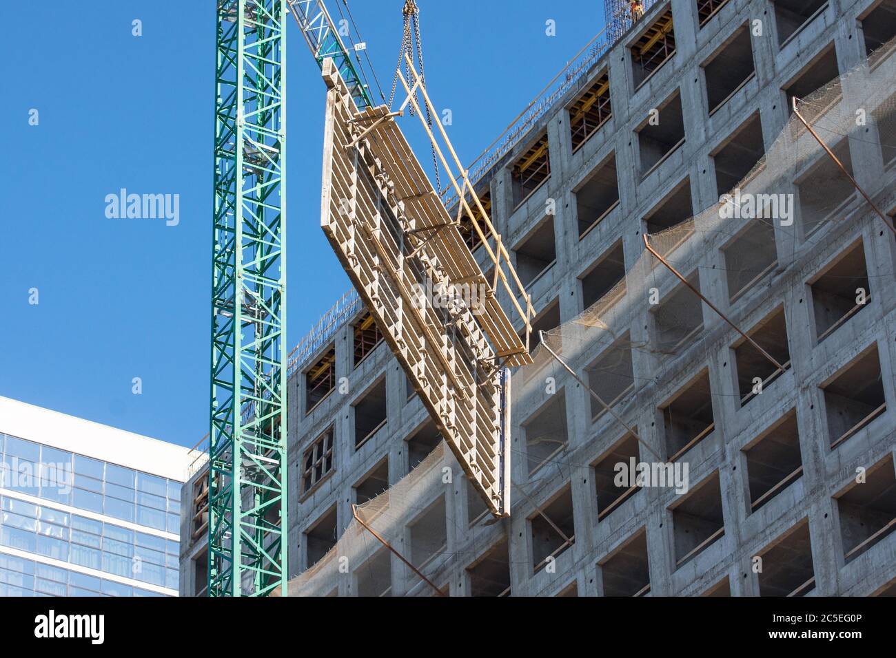 Construction of a building, crane lifts reinforcement for floors and