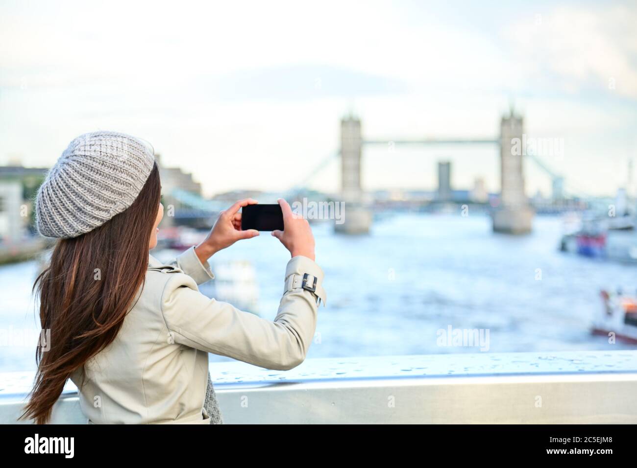 London woman tourist taking photo on Tower Bridge Stock Photo