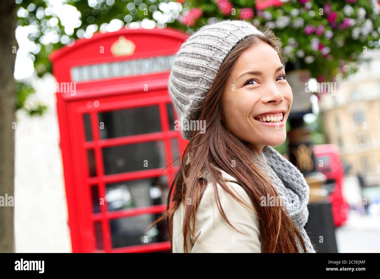 London people - woman by red phone booth Stock Photo