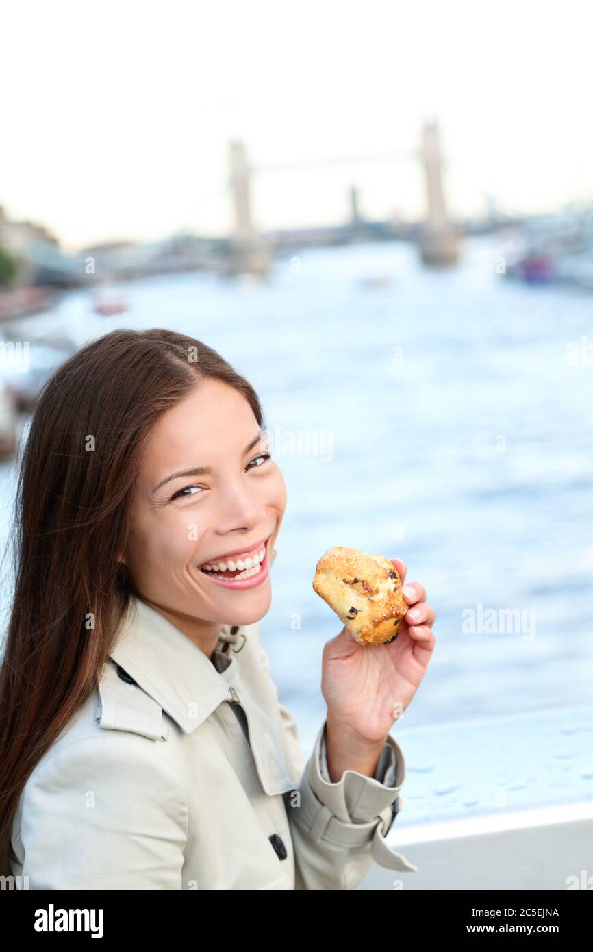 Scones - woman eating scone in London Stock Photo