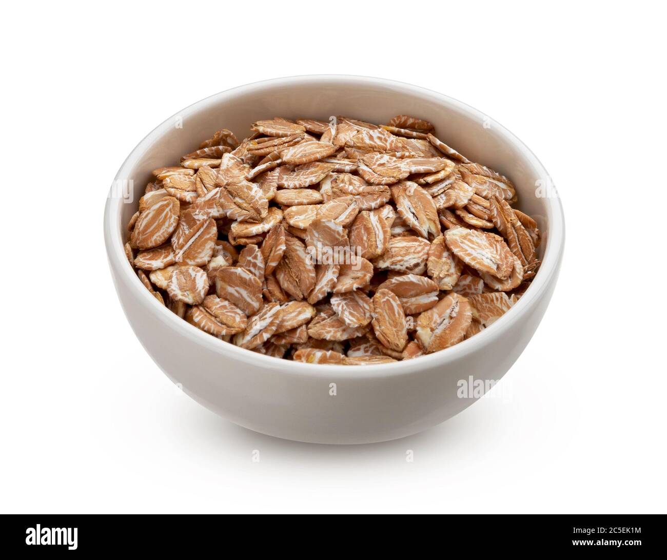 Oat rye flakes in bowl isolated on white background Stock Photo