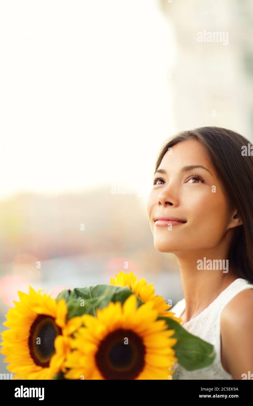 Flower woman holding sunflower smiling happy Stock Photo - Alamy