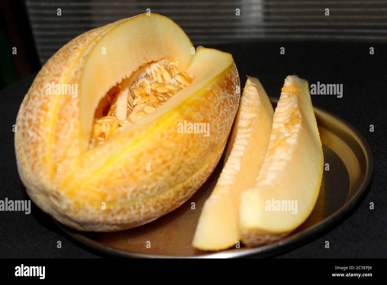 Muskmelon sugar melon fruits healthy food, whole and slice of japanese melons served in plate