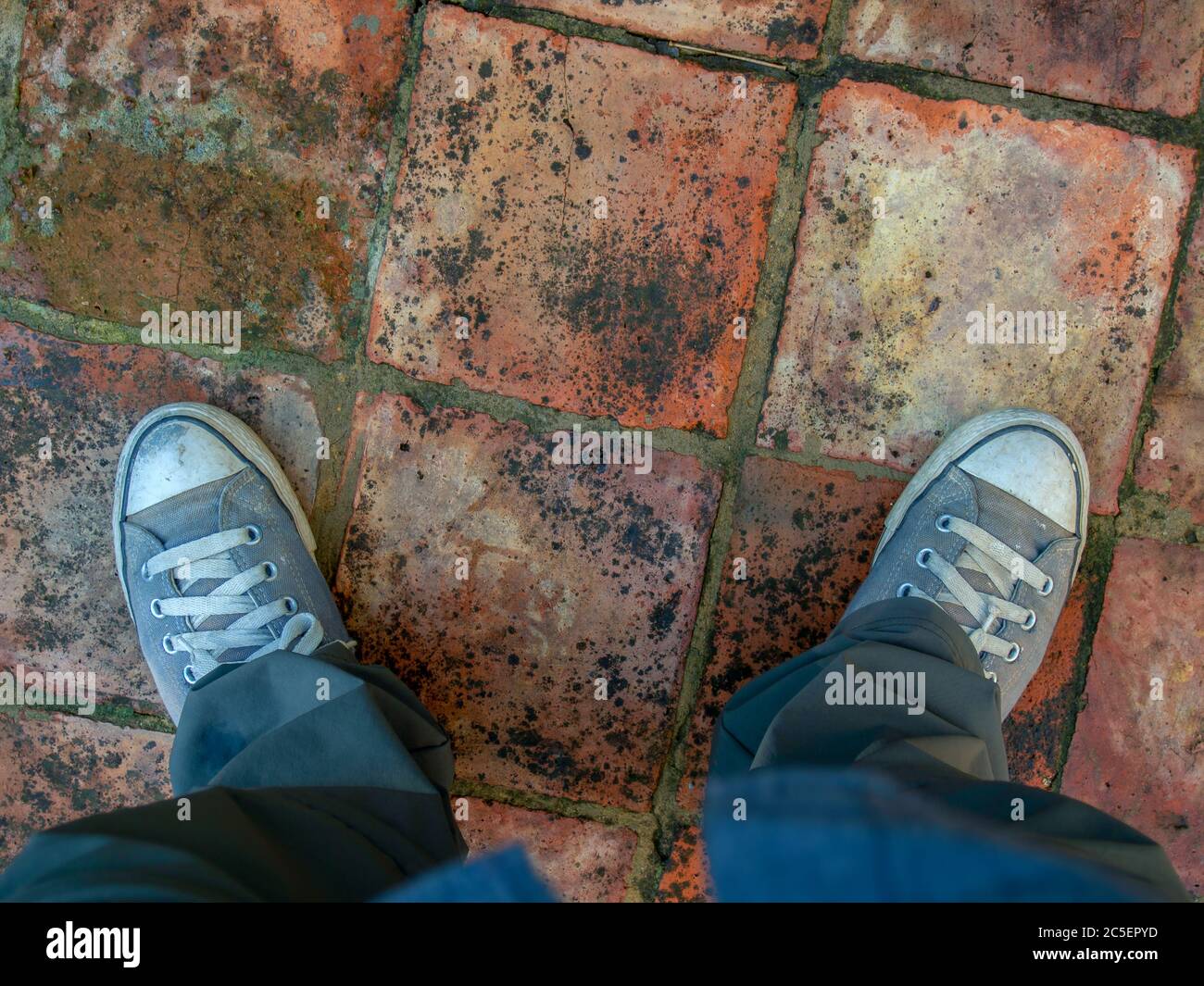 Two very worn shoes on the traditional clay tile floor of a country house  outside the colonial town of Villa de Leyva, in the central mountains of  the Stock Photo - Alamy