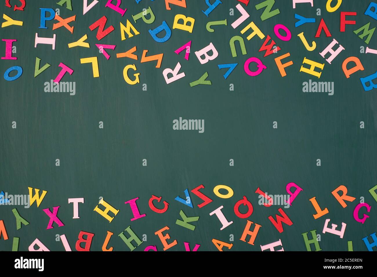 Studying english language at school concept. Top above overhead view photo of colorful letters with blank center isolated on greenboard Stock Photo
