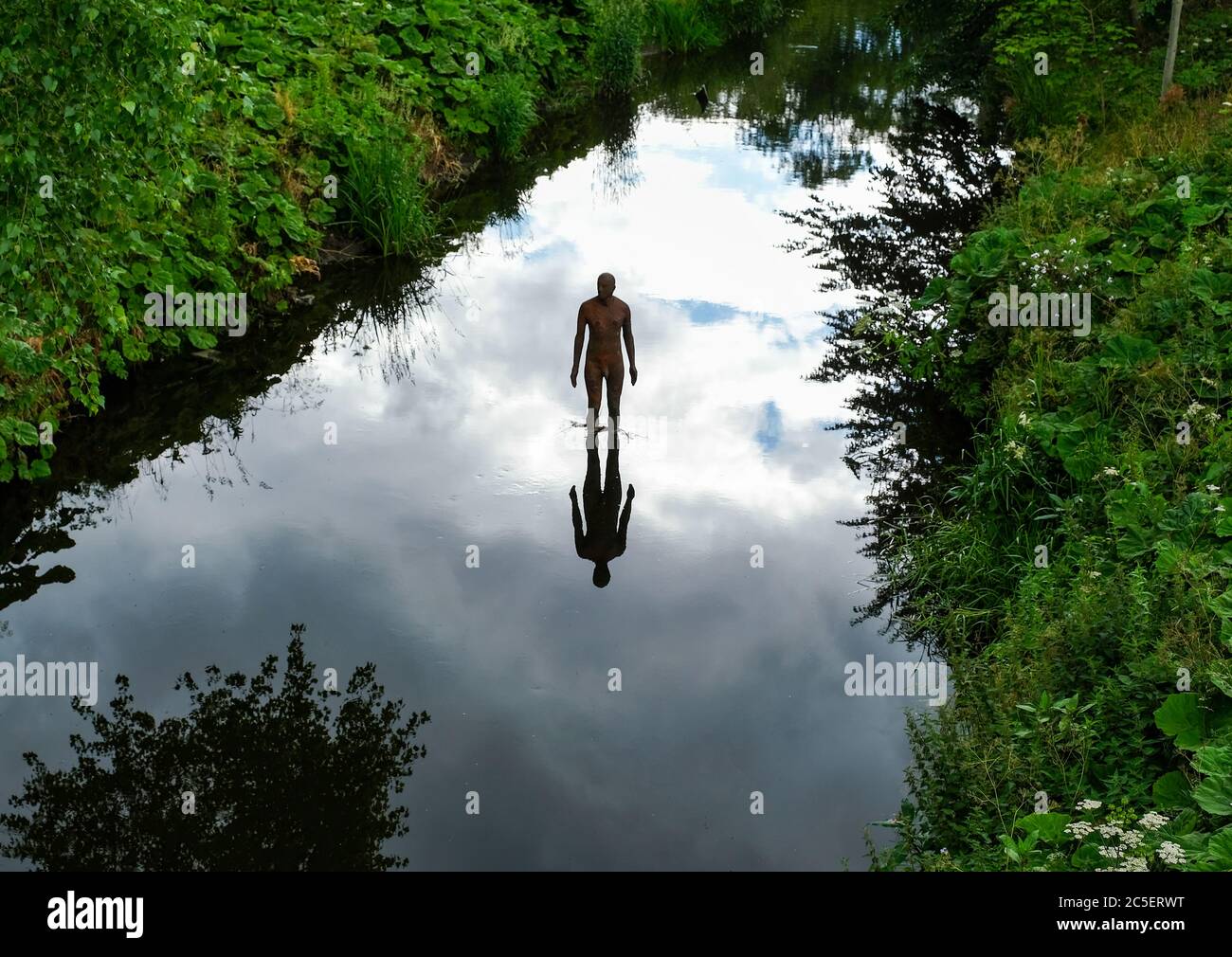 Antony Gormley sculpture in the Water of Leith at Canonmills, Edinburgh. Stock Photo